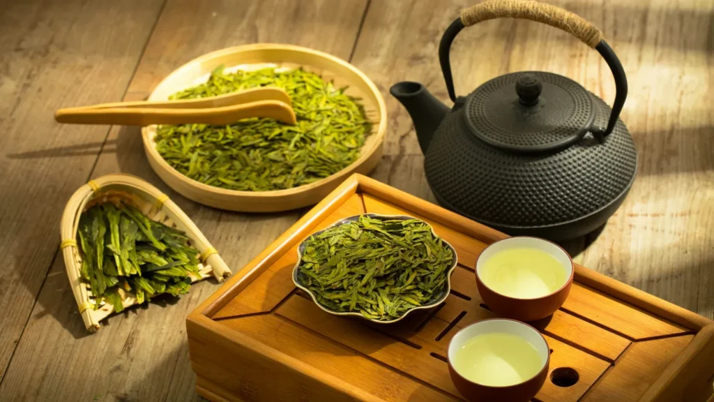 Tea set with a teapot and two cups of green tea
