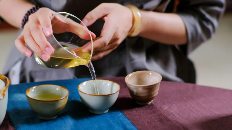 Pouring tea from a pitcher during a Chinese gongfu cha session